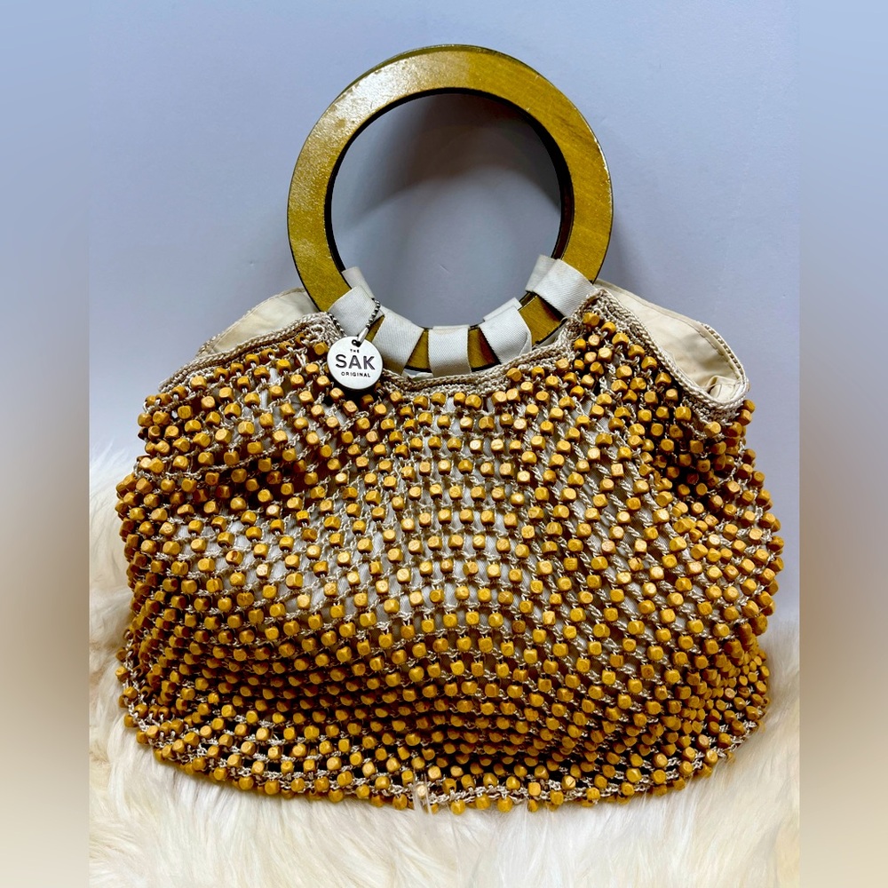 The Sak Original Tan Wood Beaded Bag w/ Round wood handles.